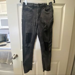 Black distressed skinny jeans with fishnet detail